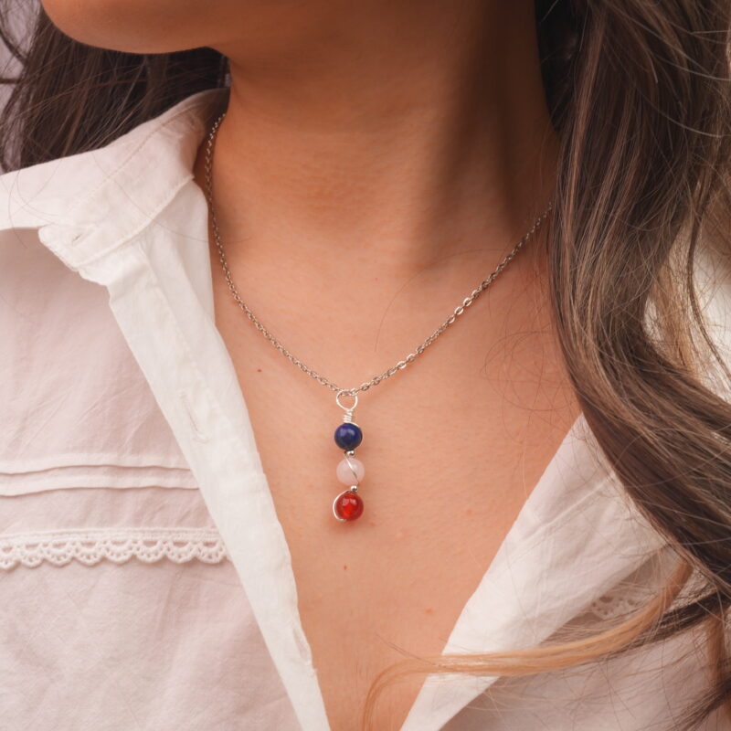 Model wearing Taurus zodiac necklace with lapis lazuli, clear quartz, and red agate.