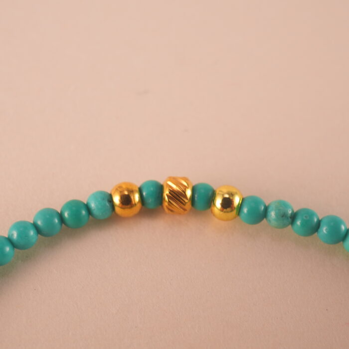 Close-up of turquoise bracelet showing natural texture and bead color.