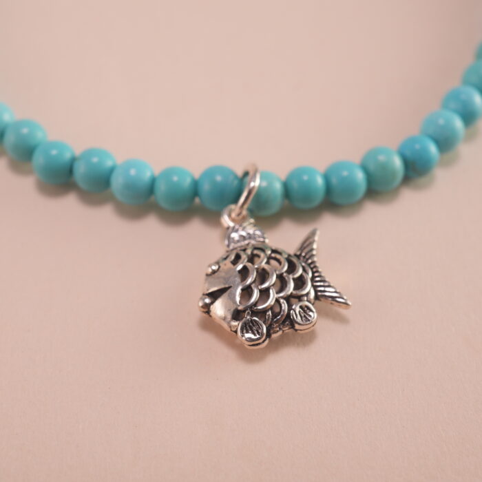 Close-up of turquoise and rhodochrosite bracelet with silver.