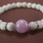 Close-up of white chalcedony and lepidolite bracelet.