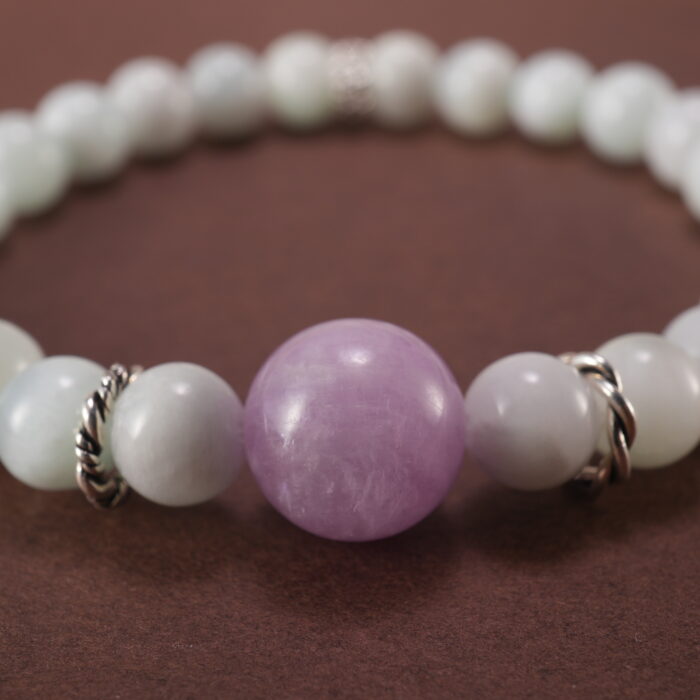 Close-up of white chalcedony and lepidolite bracelet.