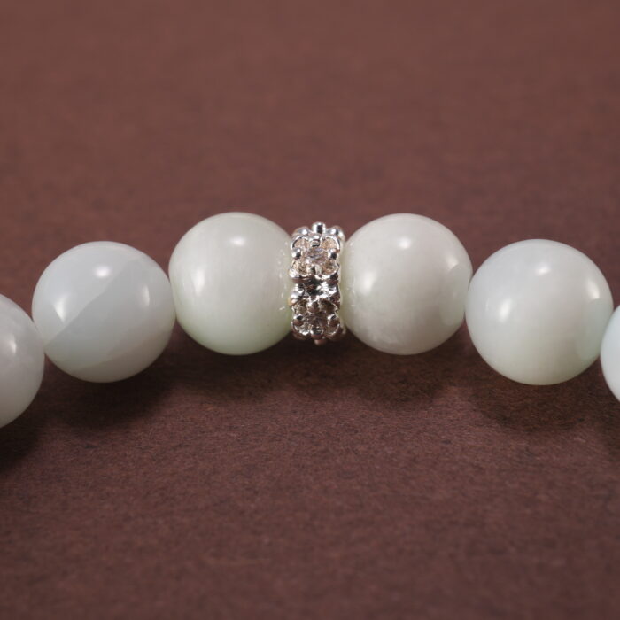 Close-up of white chalcedony and lepidolite bracelet.