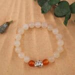 Bracelet in natural light with soft white and warm orange tones.