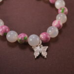 Close-up of bracelet combining white chalcedony and rainbow fluorite beads.