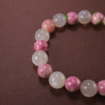 Close-up of bracelet combining white chalcedony and rainbow fluorite beads.
