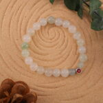 Bracelet in natural light featuring creamy chalcedony and rich ruby tones.