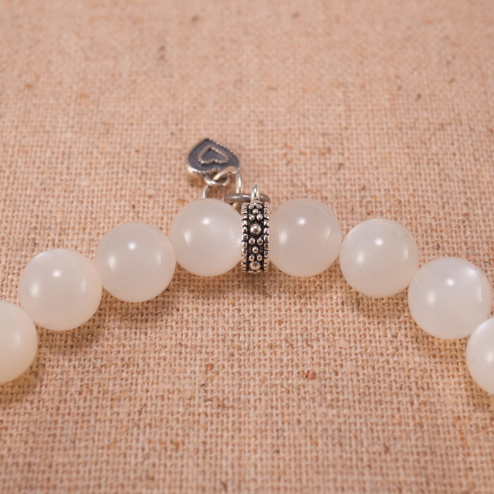 Close-up of white moonstone and blue apatite bracelet with S925 silver beads.