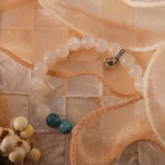 White moonstone and apatite bracelet in natural light with soft glow.