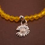 Close-up of yellow agate and cinnabar bracelet with silver.
