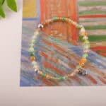 Bracelet in daylight showing citrus tones and soft green.