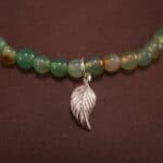 Close-up of yellow, green, and white chalcedony bracelet with silver.