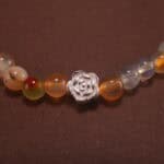 Close-up of yellow, green, and white chalcedony bracelet with silver.