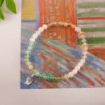 Bracelet in daylight with soft multicolor gemstone tones.