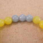 Close-up of yellow jade and blue chalcedony bracelet with S925 silver.