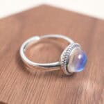 Close-up of the moonstone ring band and setting, highlighting the smooth cabochon cut and fine craftsmanship.