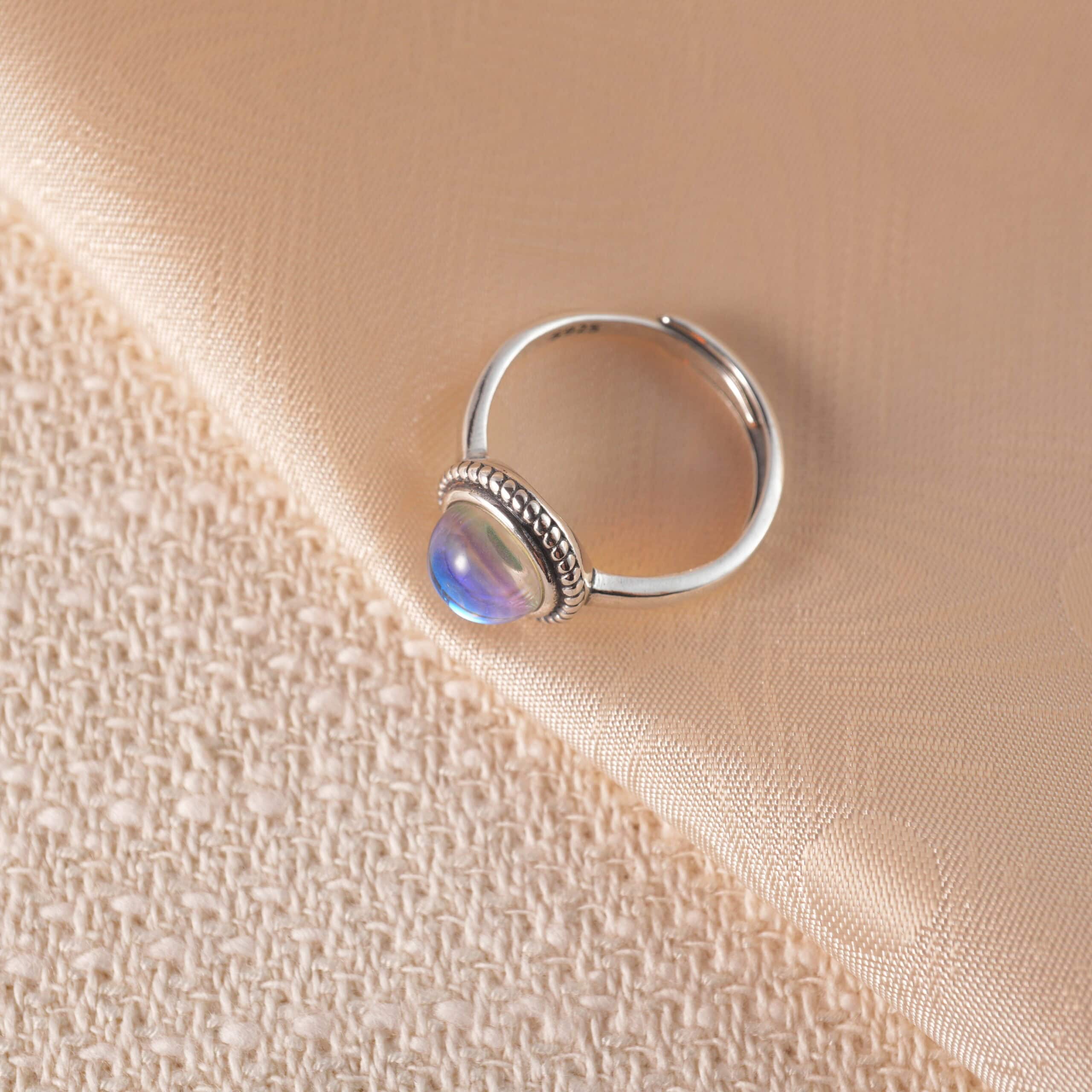 adjustable-moonstone-ring-main Adjustable moonstone ring displayed on white background, showcasing its glowing, iridescent surface.