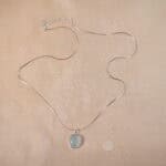 Aquamarine pendant on plain background