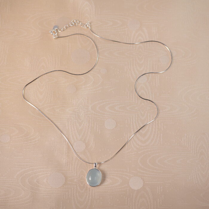 Aquamarine pendant on plain background