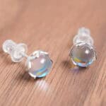 Close-up of the moonstone studs, showing blue iridescence and smooth cabochon cut.
