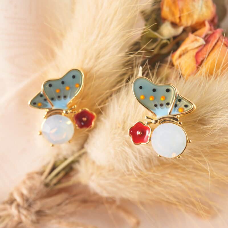 Close-up of the opal butterfly studs highlighting the shimmering finish and fine contours.