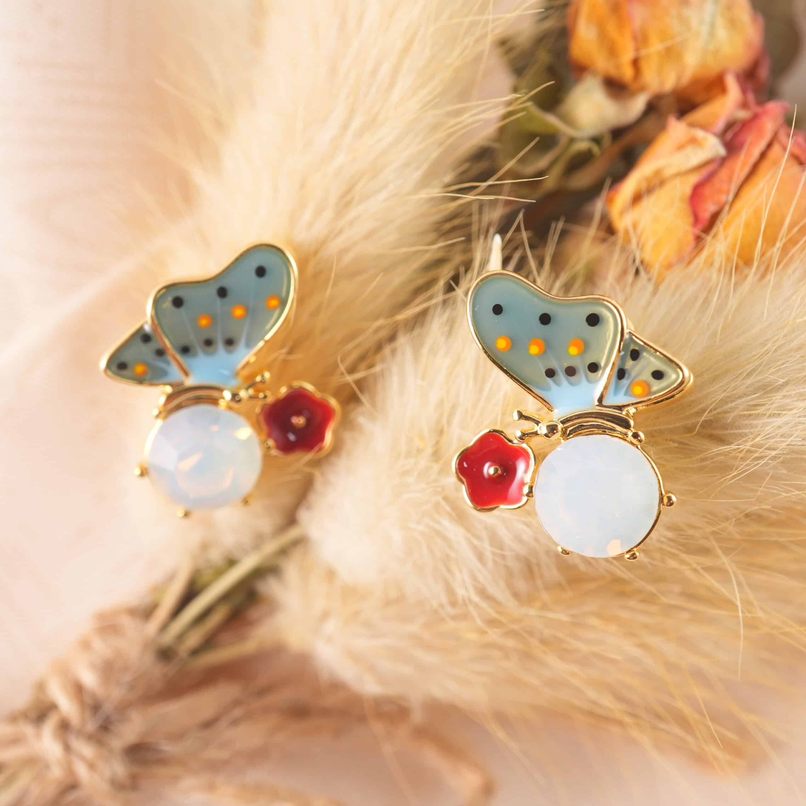 Close-up of the opal butterfly studs highlighting the shimmering finish and fine contours.