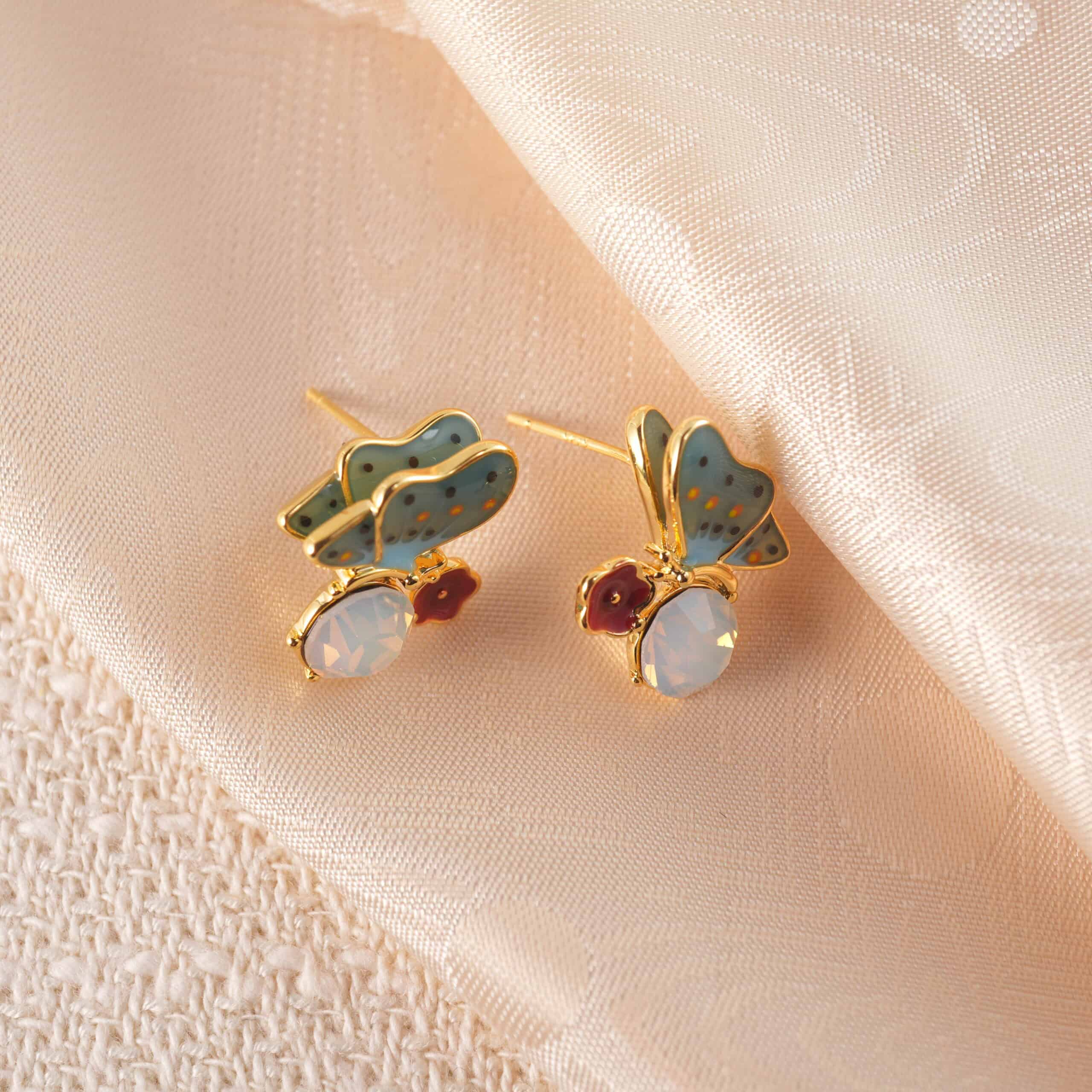 butterfly-opal-stud-earring-main A pair of butterfly-shaped opal stud earrings with soft, iridescent tones and delicate design.