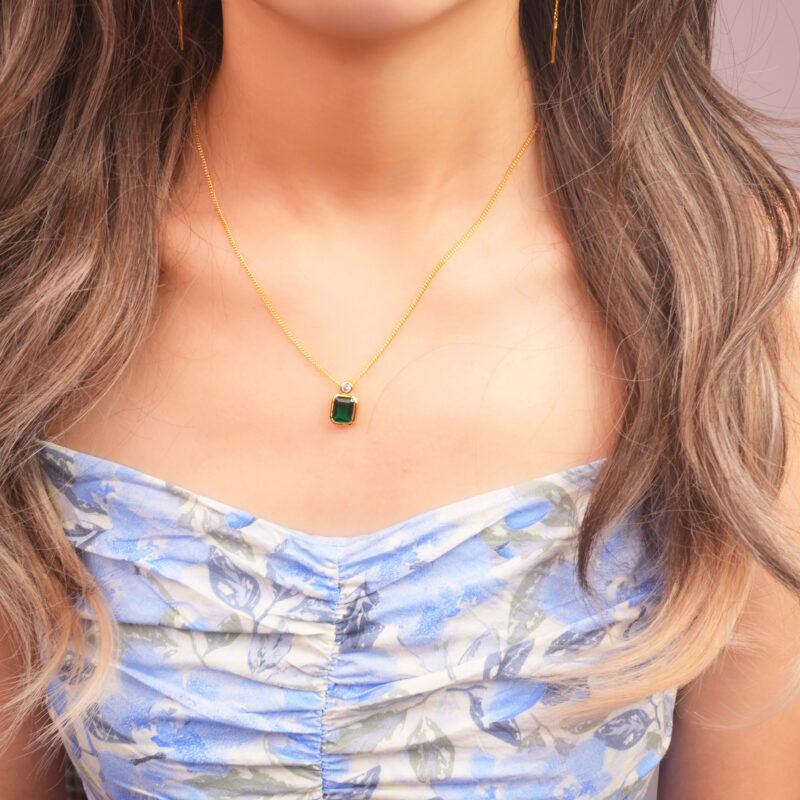 Model wearing emerald pendant necklace