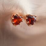 Close-up of the garnet heart studs showing the heart shape and natural gemstone luster.