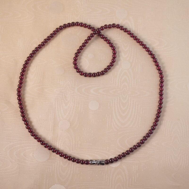 Garnet round bead necklace on white background