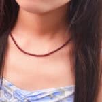 Garnet round bead necklace in warm natural lighting