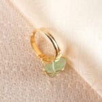 Close-up of the green fluorite crystal with delicate wire wrapping details.