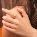 Green fluorite ring worn on a hand, highlighting its boho and healing style.