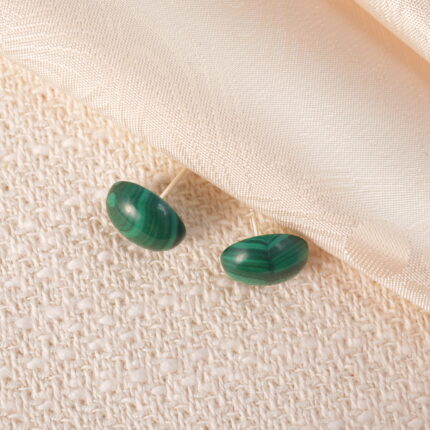 A pair of minimalist round malachite stud earrings featuring rich green patterns and natural luster.
