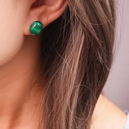 Model wearing malachite stud earrings, reflecting a natural, grounded, and stylish look.