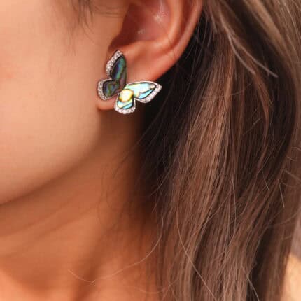 Model wearing the moonstone butterfly earrings, adding a touch of graceful charm around the ear.