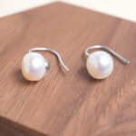 Close-up of the pearl stud earring, highlighting its smooth surface and natural shine.