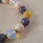 Close-up of the opal and pink chalcedony beads highlighting the natural textures and soft colors.