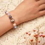Delicate opal and pink chalcedony bracelet worn on wrist, radiating a gentle and feminine vibe.