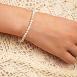 Model wearing the pearl stretch bracelet, showcasing elegant wrist lines and feminine charm.