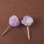 Close-up of the amethyst studs showing the unpolished crystal's natural shine and layered hues.