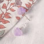 Close-up of the amethyst studs showing the unpolished crystal's natural shine and layered hues.