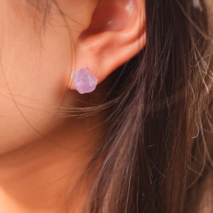 Model wearing the raw amethyst studs, showcasing a natural and spiritual fashion look.