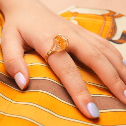Raw citrine ring worn on the finger, highlighting its bold crystal and artisanal style.