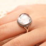 Clear quartz ring with a carved snowflake design displayed on a neutral background.