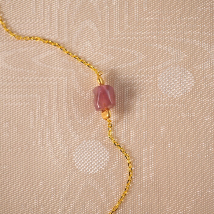 Close-up of colorful tourmaline beads on delicate necklace