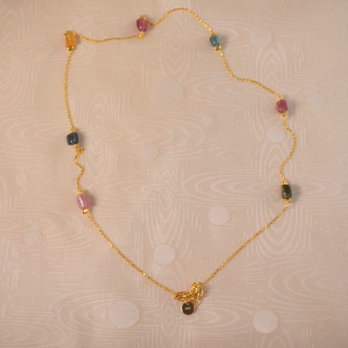 Tourmaline delicate necklace on white background
