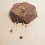 Tourmaline delicate necklace placed on wooden surface