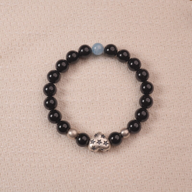 Black obsidian and aquamarine bracelet with a silver S925 heart charm, elegantly designed with shiny black beads and a subtle aquamarine centerpiece.
