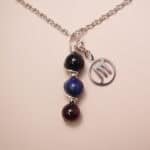 Scorpio zodiac necklace with obsidian, lapis lazuli, and garnet gemstones.