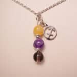Sagittarius zodiac necklace with yellow chalcedony, amethyst, and smoky quartz gemstones.